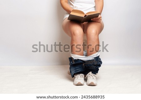 female legs with panties while sitting on the toilet