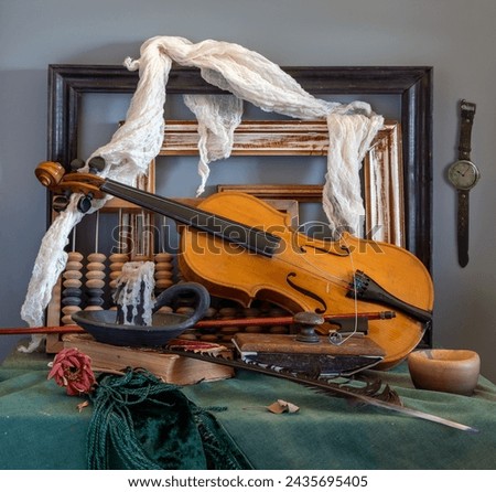 Old forgotten things. A violin with a broken string, an extinguished candle, old picture frames, a wooden abacus.