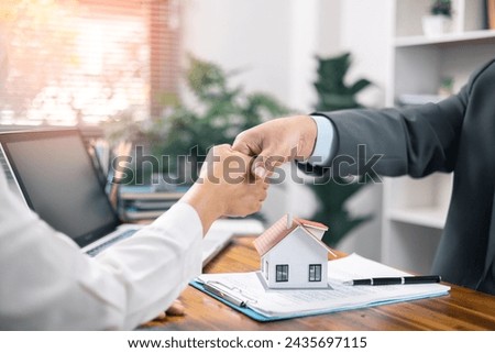 land and insurance, handshake and Good response concept. agent, lease,successful management Real estate brokerage manager with client after signing home purchase contract in real estate agency office. Royalty-Free Stock Photo #2435697115