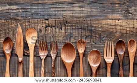 Neat arrangement of wooden cutlery on rustic wooden table for your background bussines, poster, wallpaper, banner, greeting cards, and advertising for business entities or brands.