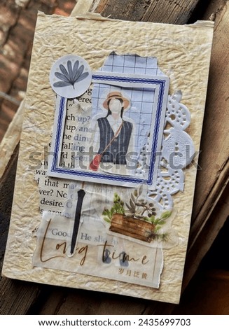 Close up picture of journal spread or scrapbook on wooden background. Journaling as a hobby.
