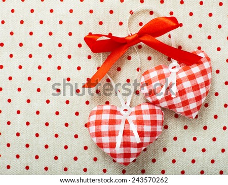 Heart made of cloth in red cell handmade Valentines Day on the background of vintage linen fabric texture. Tag labeling. 