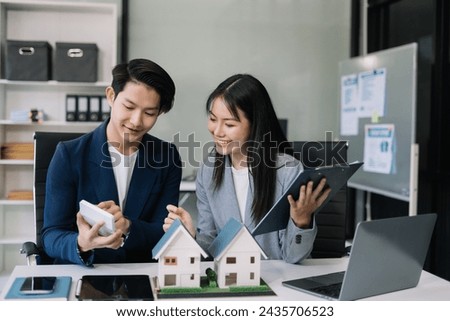 Real estate broker agent presenting and consult to customer to decision making sign insurance form agreement, home model, concerning mortgage loan offer in office.