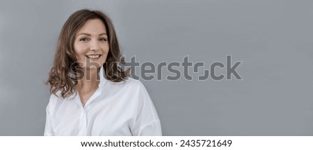 Close-up portrait of a young woman on a grey background, banner, copy space.