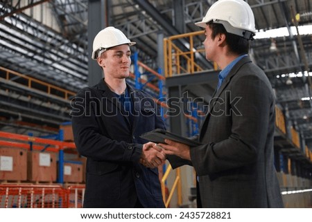 Project manager  and chief of engineer Handshake at the electrical train garage Royalty-Free Stock Photo #2435728821