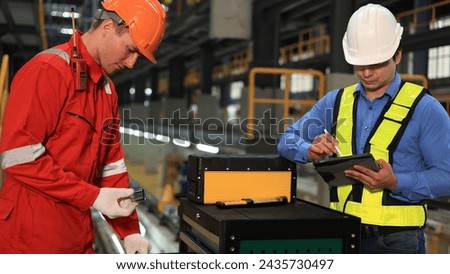 The railway chief engineer and maintenance engineer collaborate on maintaining the electric train tracks at the Sky train garage. Royalty-Free Stock Photo #2435730497