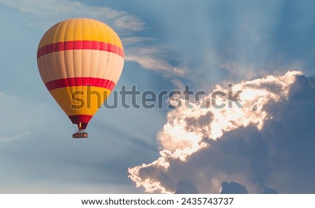 A colorful hot air balloon flying near the clouds