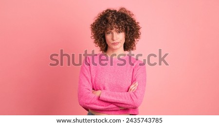 Disagreeing young woman with twisted mouth on pink background Royalty-Free Stock Photo #2435743785