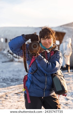Portrait of adventurous photographer woman smiling in winter in Iceland on the plane in Solheimasandur