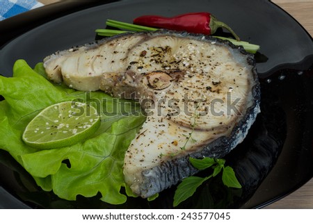 Grilled shark stesk with lime and salad leaves
