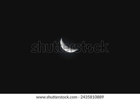 A black and white image of a crescent moon on a black background.