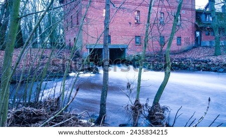 small waterworks for energy production, old building, winter, long-term exposure