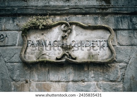antique sign indicating a pharmacy on a stone house. High quality photo