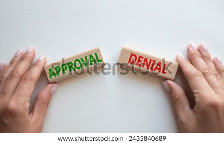 Approval or Denial symbol. Concept word Approval or Denial on wooden blocks. Businessman hand. Beautiful white background. Business and Approval or Denial concept. Copy space Royalty-Free Stock Photo #2435840689