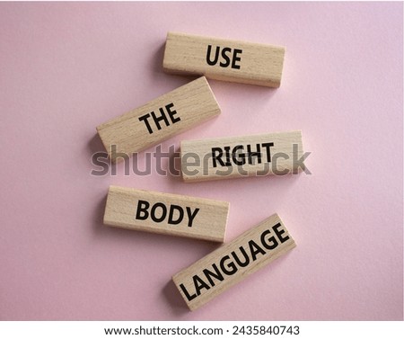 Use the right Body Language symbol. Concept words Use the right Body Language on wooden blocks. Beautiful pink background. Business concept. Copy space