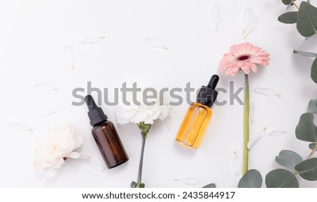 Cosmetic nature oil organic for skincare banner concept. Pipette bottle with serum and flowers on white background, place for product, top view.