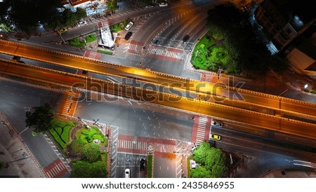 aerial night drone shot intersection Bangkok city light traffic