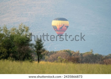 Colorful hot air balloon safari, observed in South Africa, in Pilanesberg National Park Royalty-Free Stock Photo #2435866873