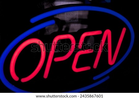 Neon Restaurant OPEN sign on a black reflection background