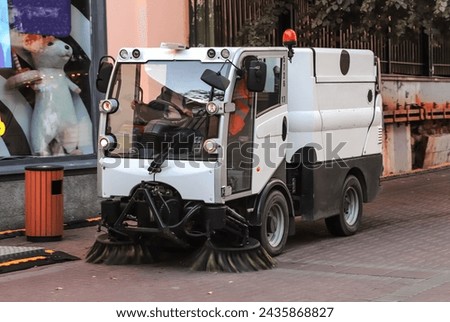 A car with a device for sweeping city streets