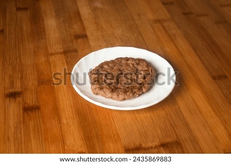 Beef Patty served in plate isolated on wooden table top view of indian food