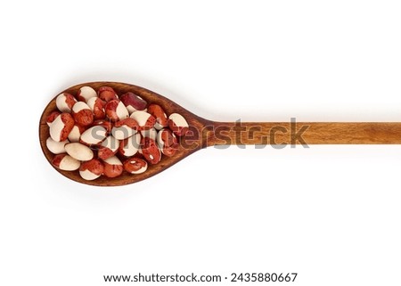Red Anasazi Beans on wooden spoon, isolated on a white background. Spotted beans. Kidney beans Royalty-Free Stock Photo #2435880667