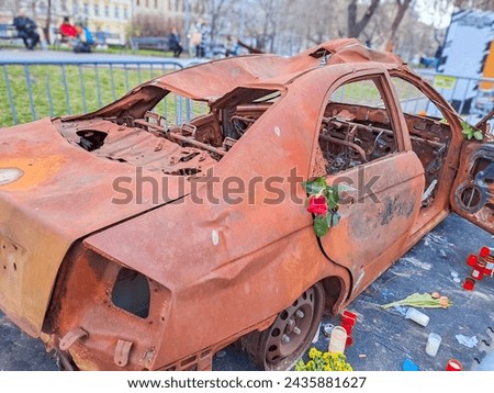 burned-out civilian car. War in Ukraine. Russian invasion of Ukraine. War crimes Royalty-Free Stock Photo #2435881627