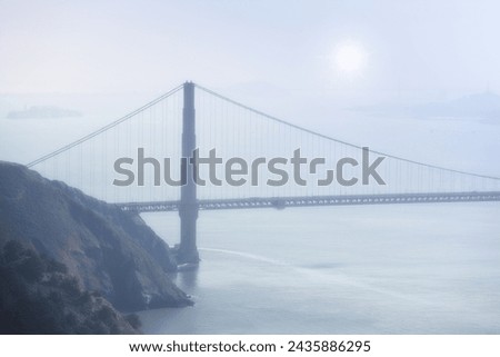 Golden Gate bridge, fog and ocean at sunrise by road, infrastructure or architecture in nature. Street, highway and hill with rocks, sea or horizon in morning sunshine for transport in San Francisco