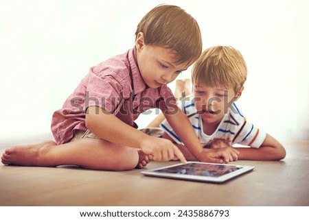 Siblings, children and tablet on a floor with cartoon, gaming or streaming movie at home. Digital, learning and boy kids in house for google it, search or ebook storytelling, app or netflix and chill