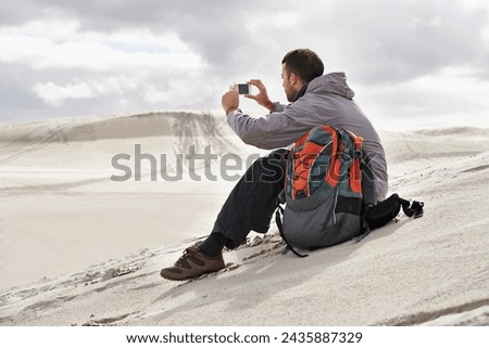 Phone, photography or man in a desert for travel, adventure or profile picture in nature. Smartphone, app and social media nomad influencer with photoshoot of sand dunes scenery on journey in Egypt