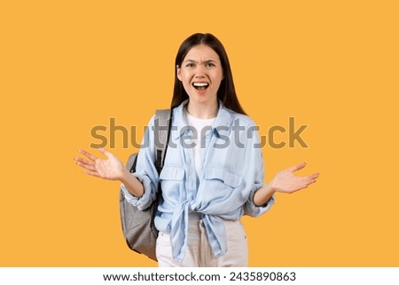 Young woman in casual attire, wearing backpack, displays an animated expression of annoyance and confusion, adding drama to everyday student scenarios Royalty-Free Stock Photo #2435890863