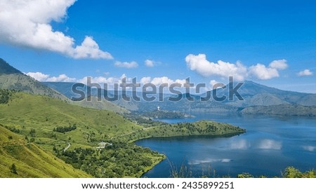 The beauty of Lake Toba and beautiful natural green hills. Natural view of the lake from the top of the hill. Beautiful nature.
