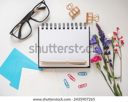 Blank notepad page for congratulatory inscriptions. Day light. Close-up, indoors. Studio shot. Finance and business concept. Congratulations for family, relatives, loved ones, friends and colleagues