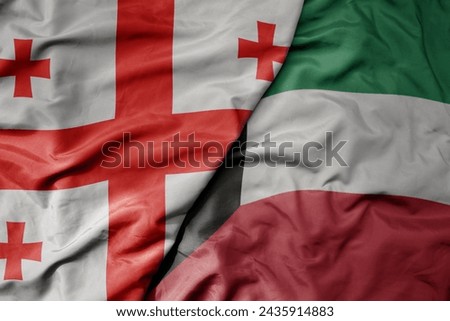 big waving national colorful flag of kuwait and national flag of georgia . macro