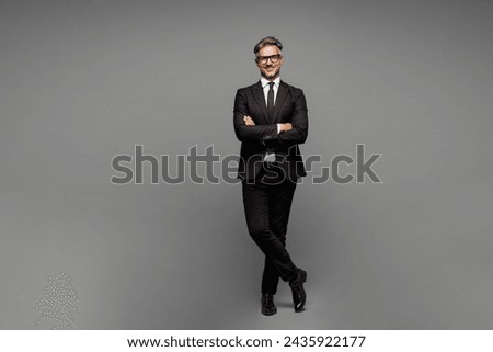 Full body adult employee business man corporate lawyer wear classic formal black suit shirt tie work in office hold hands crossed folded look camera isolated on plain grey background studio portrait Royalty-Free Stock Photo #2435922177