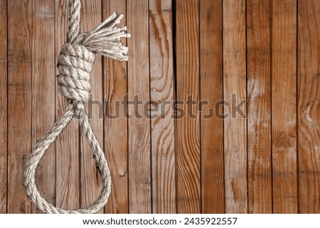 A haunting noose dangles silently—ominous symbol of despair and the weight of tragic narratives. Royalty-Free Stock Photo #2435922557