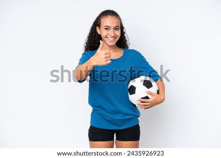 Young woman isolated on white background with soccer ball and with thumb up