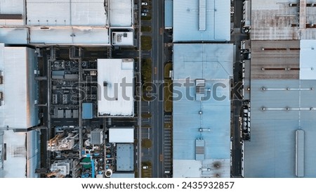 Aerial drone shot of an industrial area with many factories. Royalty-Free Stock Photo #2435932857