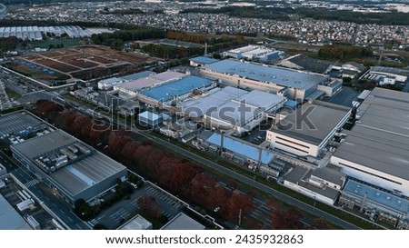 Aerial drone shot of an industrial area with many factories. Royalty-Free Stock Photo #2435932863