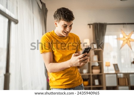 One man caucasian male teenager boy use mobile phone smartphone sms
