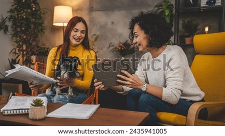 two women young caucasian female student sit at home with her mentor professor looking to the textbook explaining lesson study prepare for exam learning education concept real people copy space Royalty-Free Stock Photo #2435941005