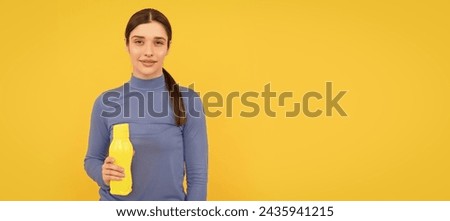 Woman isolated face portrait, banner with copy space. be hydrated. smiling woman hold mineral water. feel thirsty. young girl with sport plastic bottle. Royalty-Free Stock Photo #2435941215