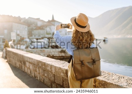 Woman taking picture of amazing landscape  on smartphone during vacation. Lifestyle, travel, tourism, active life.