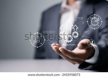 Process to increase productivity concept. Businessman holding productivity icon on virtual screen for industrial management in efficiency and efficient process. Lean cost and productivity growth.  Royalty-Free Stock Photo #2435958073