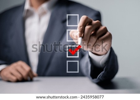 Checklist concept. Businessman checking mark on checkboxes on virtual screen.
