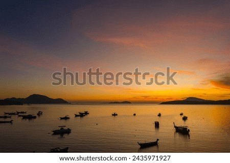 aerial view scenery yellow sky over the island at sunrise.
beautiful sky of sunrise at Rawai beach Phuket Thailand
image for travel concept. cloud in sky background.

