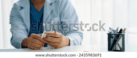 Doctor at hospital sit at his desk working on paperwork diagnosing patient test results, developing treatment plan for illnesses and sicknesses. Medical staff and healthcare service. Panorama Rigid