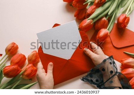 Girl holding an empty envelope with space for text, concept Happy Mother's Day, Happy Valentine's Day.