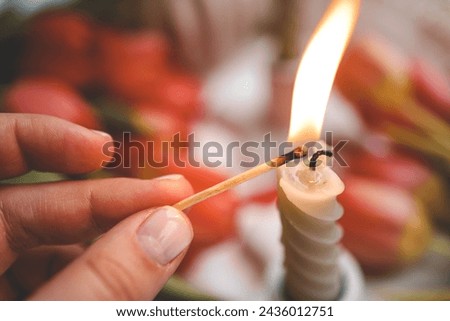 Girl lights a candle, spring aesthetics.