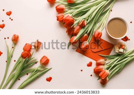 Cup of coffee, bouquet of red tulips and laptop top view flat lay, festive background.